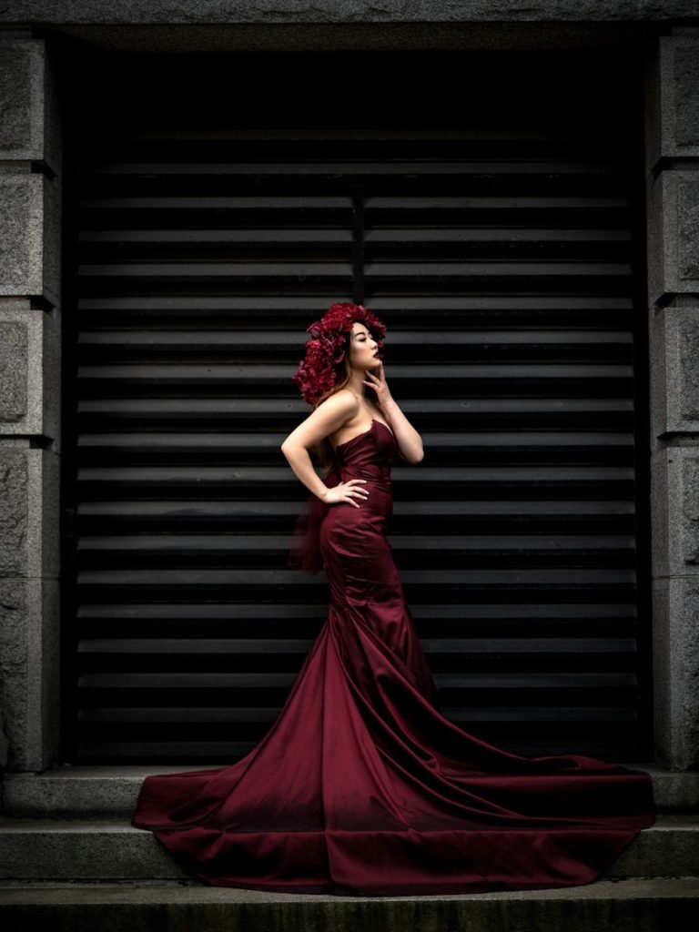 Model in an emerald midi dress
