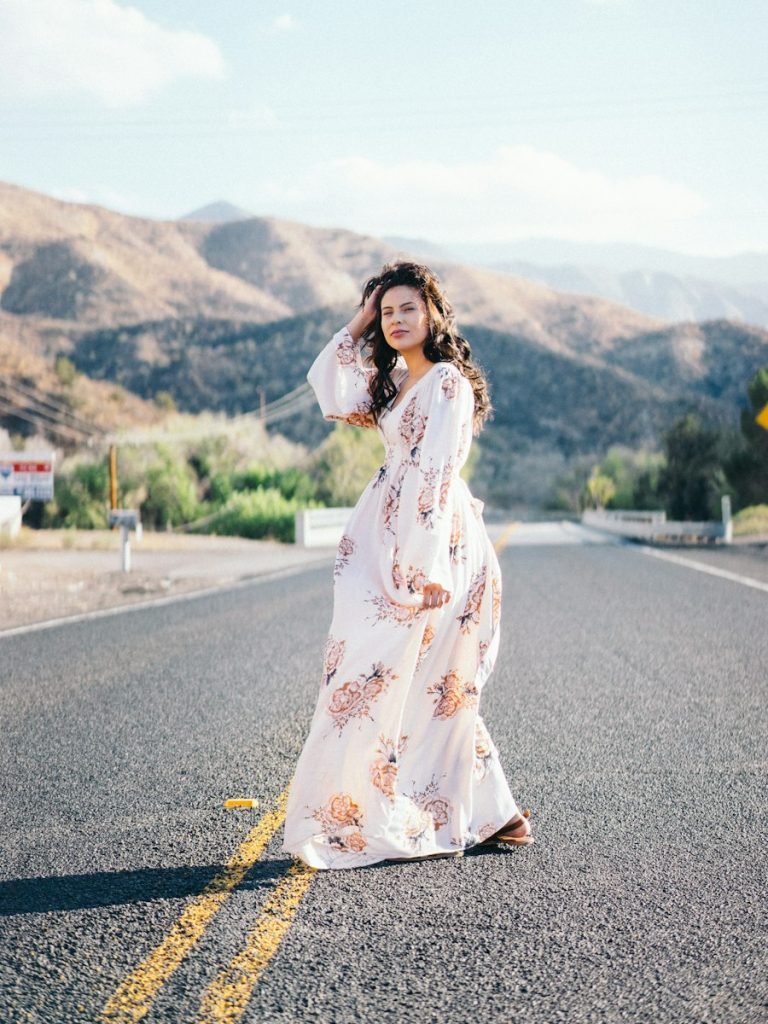 Model in a flowing blue maxi dress